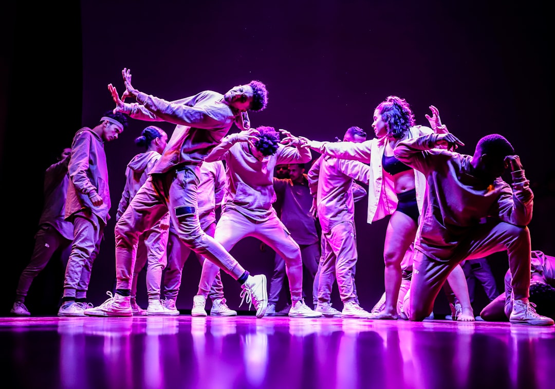 group-of-men-in-green-and-white-shirts-dancing-on-stage-xjfbvg1edam